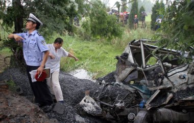 Chinese rescue workers and police officers search a crashed passenger car for victims and survivors in Zhonghan Town, Chaohu city, east Chinas Anhui province 12 June 2007 clipart