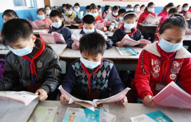 Chinese students wearing masks against the H1N1 flu are seen during a class at a school in Zhoushan city, east Chinas Zhejiang province, 4 December 2009 clipart