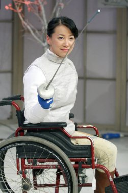 Jin Jing, the Chinese disabled torchbearer, prepares to fence during a TV talk show in Shanghai, April 20, 2008 clipart