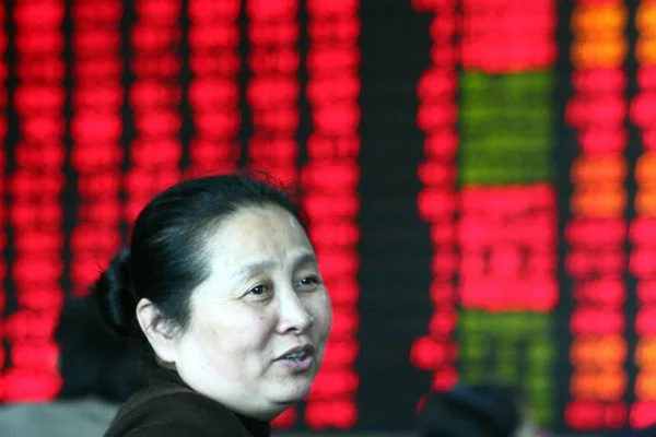 Ein Chinesischer Investor Lächelt Vor Einem Tisch Mit Den Aktienpreisen — Stockfoto
