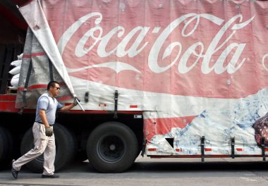 A Chinese worker removes the canvas on a Coca-Cola truck at the bottling plant of Shanghai Shen-Mei Beverage and Food Co., Ltd., partly owned by Coca-Cola, in Shanghai, China, 11 September 2009 clipart