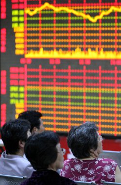 Chinese investors look at share prices at a stock brokerage house in Fuyang city, east Chinas Anhui province, 29 September 2009 clipart