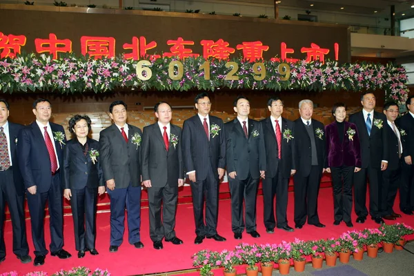 Cui Dianguo, sixth left, Chairman of China CNR Corporation, Xi Guohua, fifth left, President of China CNR Corporation, and other officials and executives are seen at a ceremony for the listing of China CNR Corporation Limited at the Shanghai Stock Ex