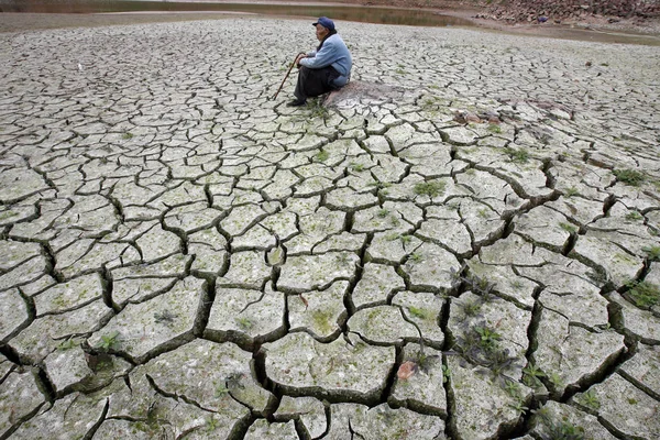 2007年3月16日 中国南西部四川省成都の干上がった貯水池に老人が座っている — ストック写真