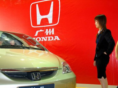 File photo dated 22 September 2005 shows a Chinese woman viewing a Honda Fit at a car show in Jinan, Shandong province clipart