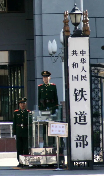 --FILE-- Chinese paramilitary police stand guard at the entrance of the headquarters and head office of Ministry of Railways in Beijing 23 March 2008.