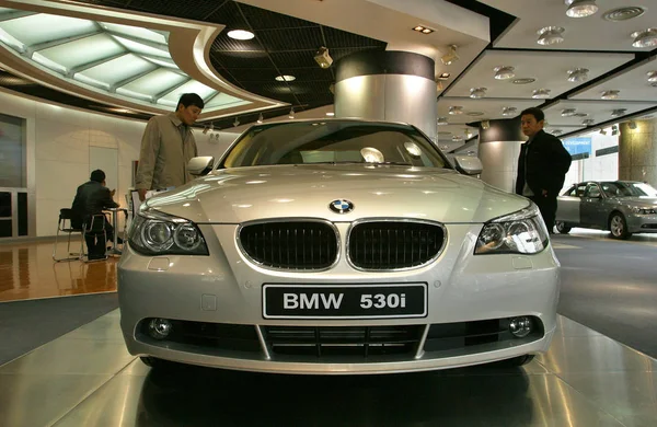 中国の車の購入者は 上海市の Bmw ディーラー店で Bmw 530I を見る — ストック写真