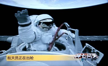 This TV screen shot from CCTV (China Central Television) shows Chinese taikonaut (astronaut) Zhai Zhigang waving to a camera while walking out of the orbital module (capsule) of the Shenzhou VII manned spacecraft for Chinas first spacewalk, Saturday, clipart
