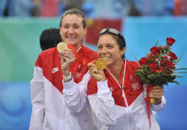 Gold medalists, Kerri Walsh (L) and Misty May of USA pose during the awarding ceremony of womens beach volleyball, at Beijing 2008 Olympic Games, at Beijings Chaoyang Park Beach Volleyball Ground, in Beijing, August 21, 2008. clipart