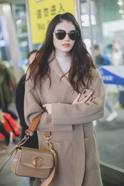 File--In this undated photo, Chinese model He Sui arrives at a Shanghai  airport befoere departure in Shanghai, China. Shoulder bag: Louis Vuitton  (Photo by Wang Jiali/ChinaImages/Sipa USA Stock Photo - Alamy