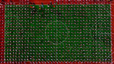 Thousands of primary school students gather at a football field to chant and praise mother country in Shenyang city, northeast China's Liaoning province, 30 April 2019. clipart