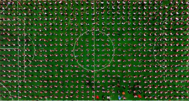 Thousands of primary school students gather at a football field to chant and praise mother country in Shenyang city, northeast China's Liaoning province, 30 April 2019. clipart