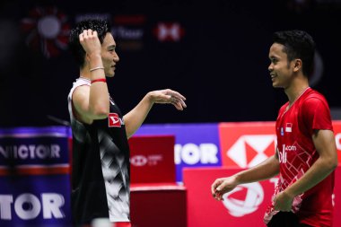 Japanese professional badminton player Kento Momota, left, and Indonesian professional badminton player Anthony Sinisuka Ginting, right, greet at the final of men's single of VICTOR China Open 2019, in Changzhou city, east China's Jiangsu province, 2 clipart