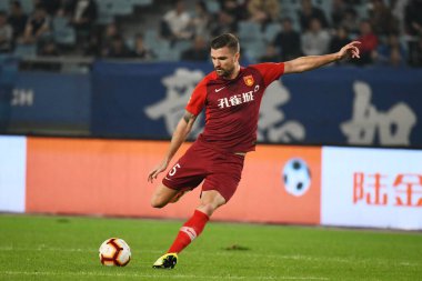 Hong Kong football player Andy Russell of Hebei China Fortune F.C. shoots the ball during the 26th round match of Chinese Football Association Super League (CSL) against Jiangsu Suning in Nanjing city, east China's Jiangsu province, 20 October 2019