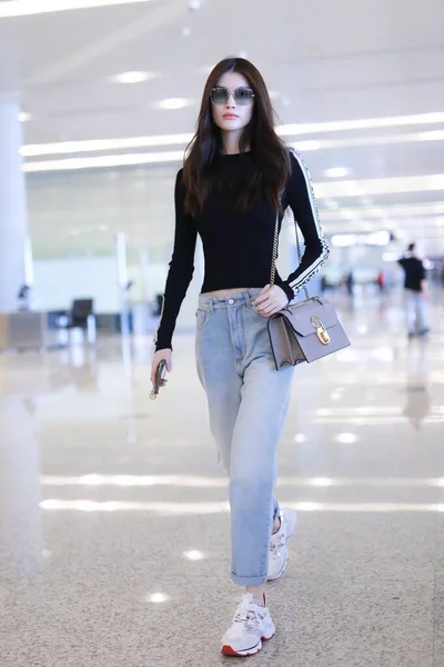 File--In this undated photo, Chinese model He Sui arrives at a Shanghai  airport befoere departure in Shanghai, China. Shoulder bag: Louis Vuitton  (Photo by Wang Jiali/ChinaImages/Sipa USA Stock Photo - Alamy