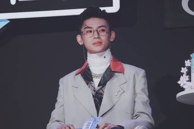 Chinese rapper and singer-songwriter Wang Linkai, commonly known by his stage name Xiao Gui, shows up in suit and black jeans in the final of Chinese reality show Youth with You Season 2, alternatively known as Idol Producer Season 3, Guangzhou city, clipart