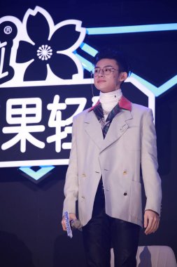 Chinese rapper and singer-songwriter Wang Linkai, commonly known by his stage name Xiao Gui, shows up in suit and black jeans in the final of Chinese reality show Youth with You Season 2, alternatively known as Idol Producer Season 3, Guangzhou city, clipart