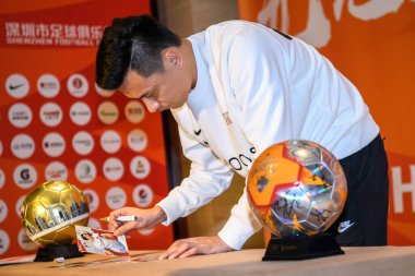 Chinese footballer Gao Lin accepts the trophy as he wins the MVP during the 11th round of Chinese Super League, Dalian city, northeast China's Liaoning province, 20 September 2020.  clipart