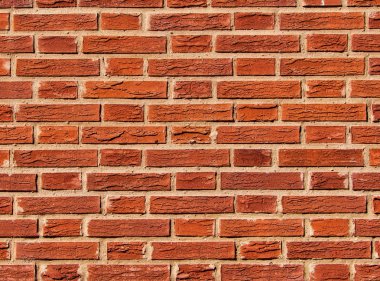 Arka plan doku deseni olarak kullanılan soyma boyası ile kırmızıya boyanmış tuğla duvar