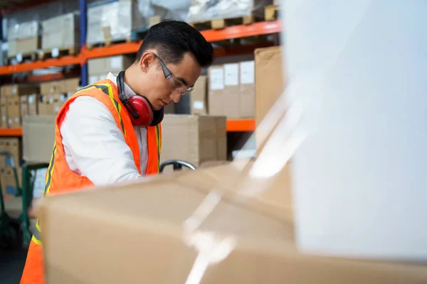 Employee of a logistics warehouse takes an inventory of goods