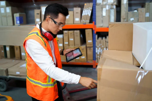 Employee of a logistics warehouse takes an inventory of goods