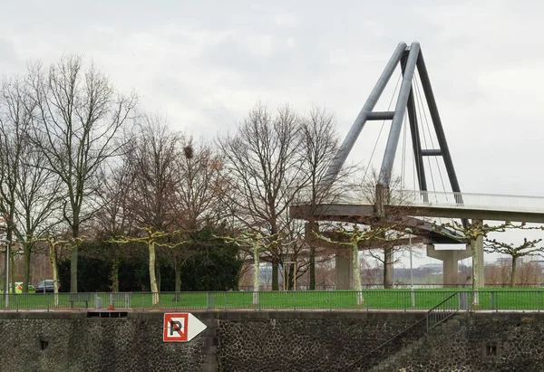 view of  bridge element, no stop sign, fragment, led  pedestrian bridge in the rain against the background of grass and trees