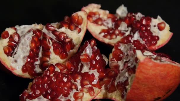 Delicious pomegranate. Portion of fresh made pomegranate isolated on a black background. — Stock Video