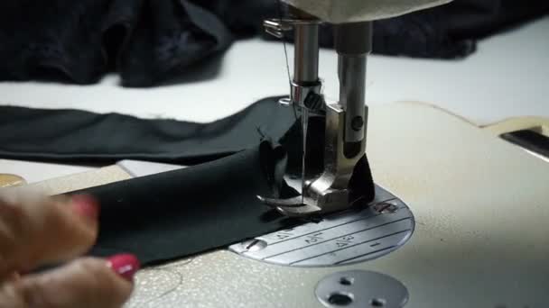 Close-up. Woman hands working with sewing machine. Factory textile sewing. — Stock Video
