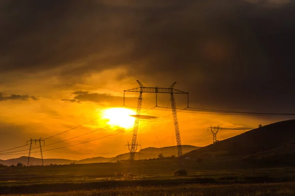 vivid sun lighted cloudy sky with electric towers