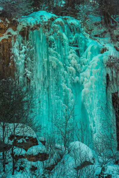 Huge cold icicles on nature background