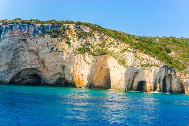 deniz, kayalar ve mavi bulutlu gökyüzü ısmarlayarak