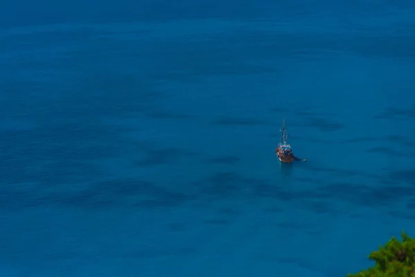 deep blue ocean water and floating boat
