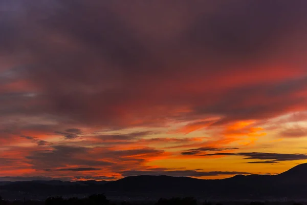 丘の上の劇的な曇り夕焼け空 — ストック写真