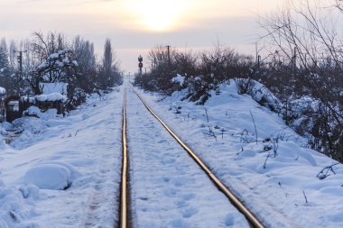 white snow covered land, winter season in countryside with railway 