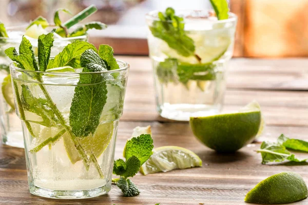 mojito cocktail with rum, lime and soda, garnished with mint, close up