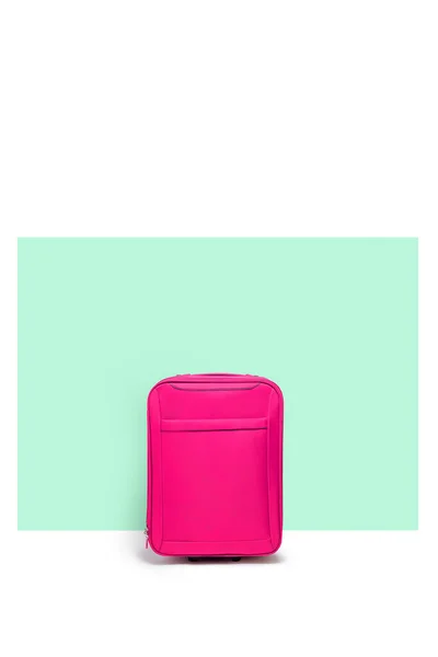 Pink suitcase standing next to the blue pastel color wall. Travel concept — Stock Photo, Image