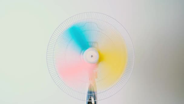 Rotating Electric Fan Multi Colored Blades Forming Fun Rainbow Effect — Stock Video