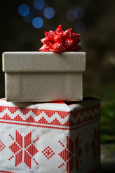 Stacked Christmas Presents Wrapped Festive Paper Adorned Red Bow Defocused — Stock Photo, Image