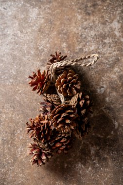 Kahverengi grunge dokusuna, mutlu noellere ve yeni yıllara bağlı kozalaklı çam kozalakları. 