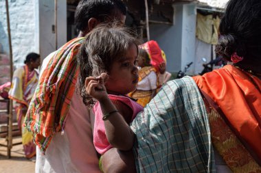 Chitapur, Karnataka / Hindistan - 12 Aralık 2019; Hint büyükanne torununu pazar alanında tutuyor.