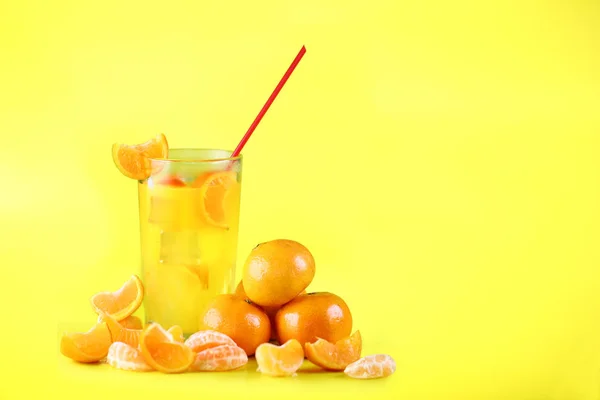 Fresh Orange drink with fresh fruit isolated in yellow background