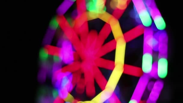 Defocused Ferris Wheel Colorful Fluorescent Lamp Lighting Decoration Rotates Slowly — Stock Video