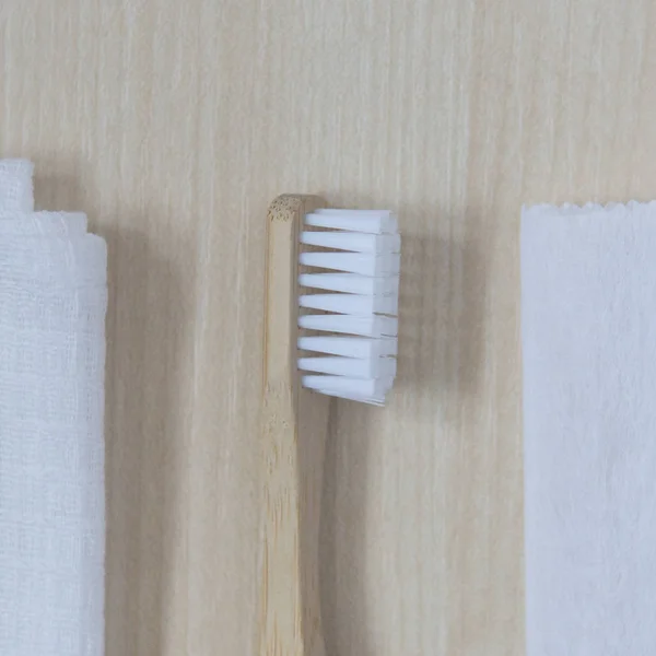 Bamboo Toothbrush Lies White Towel Light Wooden Background Natural Light — Stock Photo, Image