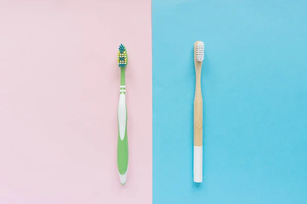 Natural bamboo toothbrush versus plastic green brush — Stock Photo, Image