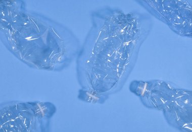 Plastic bottles isolated on blue background. Recycle waste management concept. Plastic Pet Bottles.