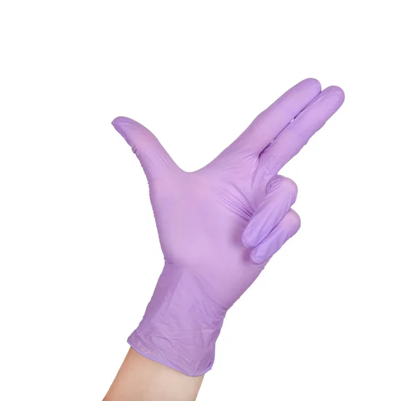Mano en un guante de látex púrpura aislado en blanco. gesto de la mano de la mujer o signo aislado en blanco . — Foto de Stock