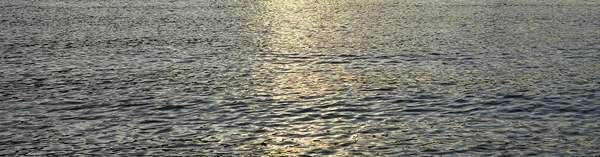 Small Water waves are moving in the river. Texture or background. Evening sun in river water. — 스톡 사진