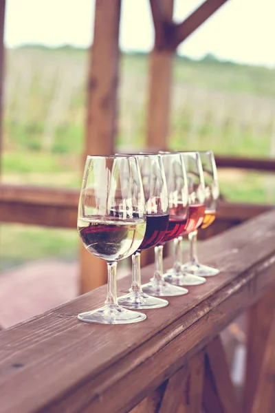 Glasses with wine. Red, pink, white wine in glasses. set of glasses with red, white and rose wine Tasting wine in the vineyard.