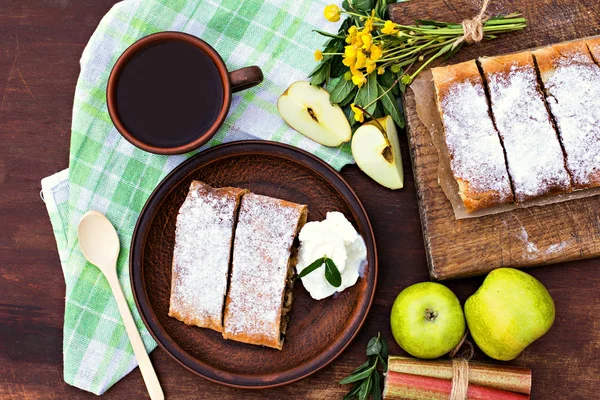 Strudel with apples and strawberries. Pie with apples or Classic apple strudel, summer pie. Summer breakfast in nature.