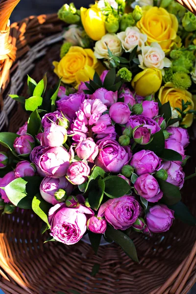 A bouquet of peonies. Beautiful bouquets of flowers on the market. Showcase with flowers. Sale of flowers, shop.